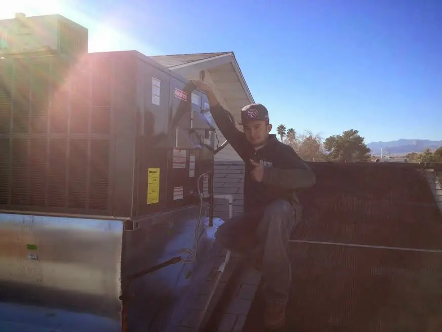 HVAC technician performing HVAC Inspection on a rooftop unit in Rutland